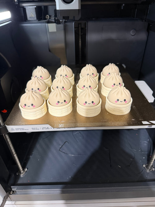 Real GoodVibes3D Dumpling Clickers freshly 3D printed on the printer bed